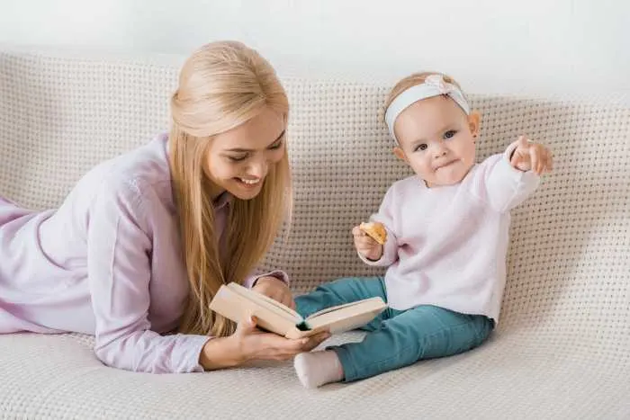 Baby and mom reading a book together