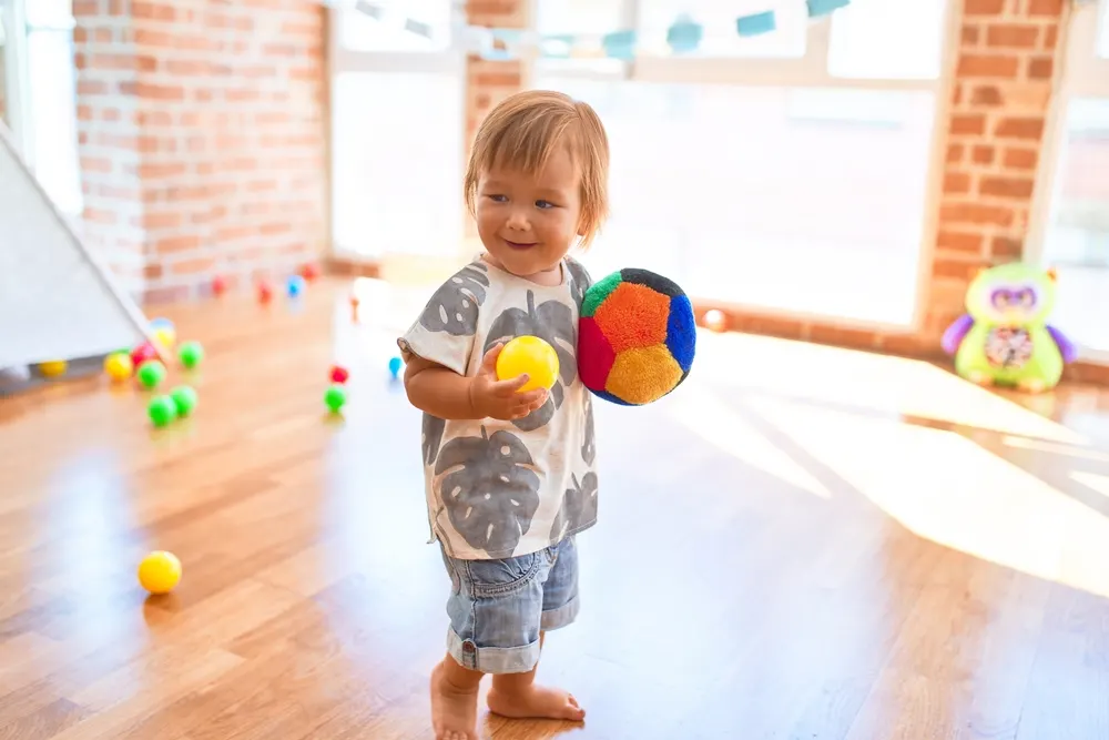 toddler holding balls