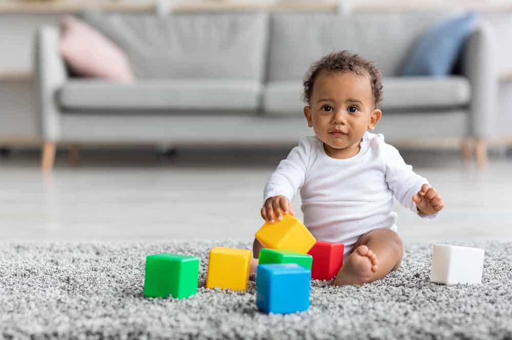 Baby playig with blocks on the floor
